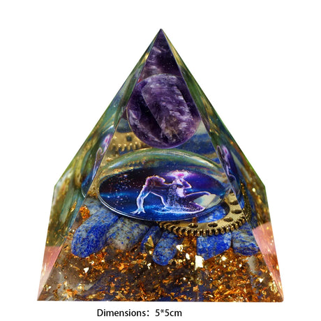 Pyramid-shaped crystal with embedded stones and a celestial design on a white background