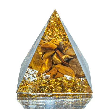 Crystal pyramid with embedded stones on a white background