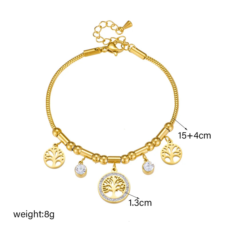 Gold bracelet with charms on a white background