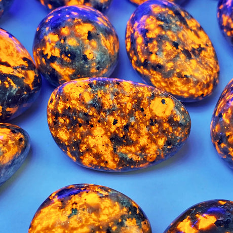Close-up of amber-colored stones with a blue background