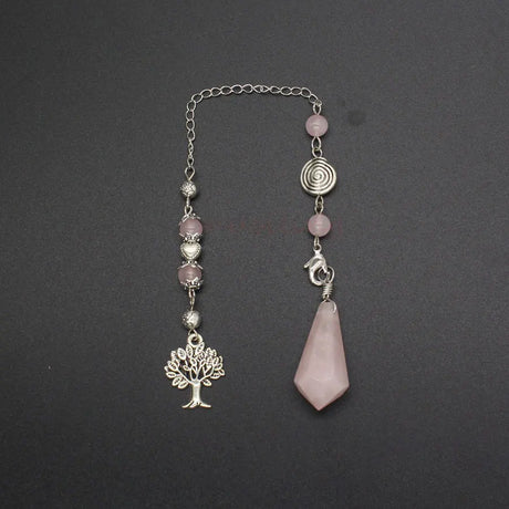 Necklace with pink beads and silver tree pendant on a dark background