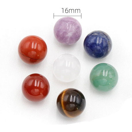 Set of colorful spherical stones with a measurement label on a white background