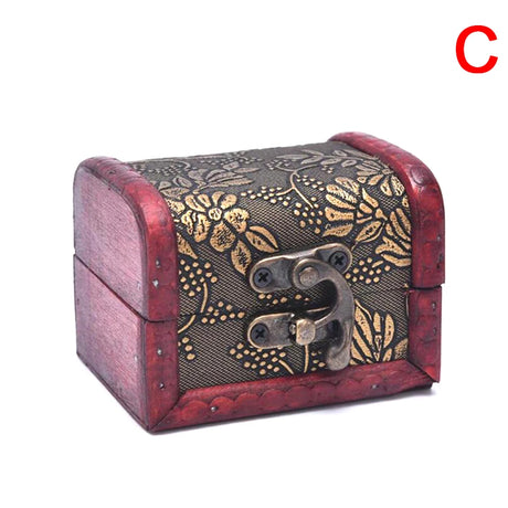 Wooden jewelry box with floral patterns and a metal clasp on a white background