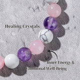 Necklace with pink, purple, and white beads on a textured surface with text about healing crystals.