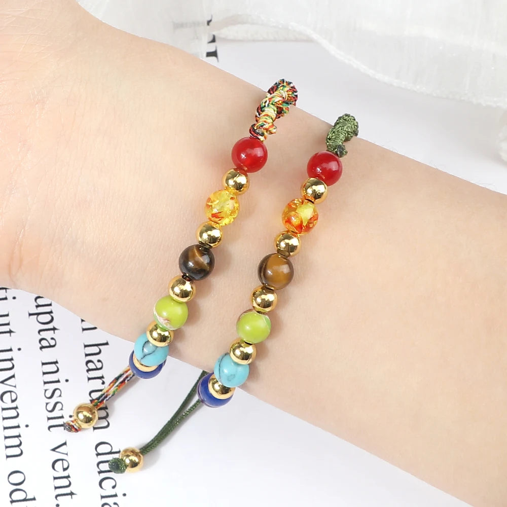 Colorful beaded bracelet on a wrist with a white background