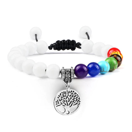 Bracelet with white beads, colorful beads, and a tree of life charm on a white background