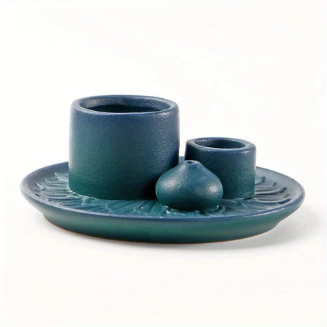 Set of blue ceramic items including a cup, saucer, and small bowl on a white background