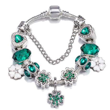 Bracelet with green and white charms on a white background