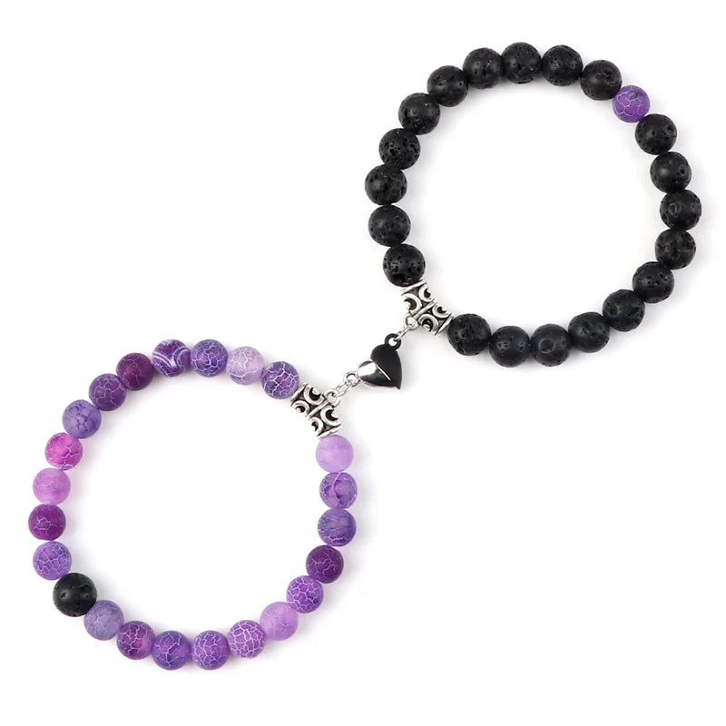 Two beaded bracelets, one purple and one black, on a white background.