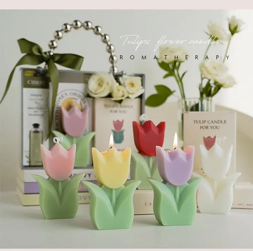Colorful tulip-shaped candles with aromatherapy packaging in the background.