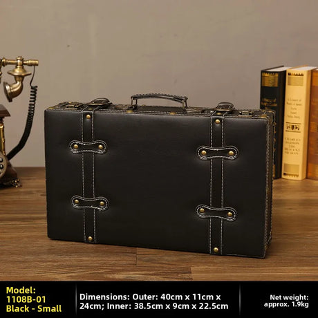 Black leather briefcase on a wooden surface with books and a vintage phone in the background