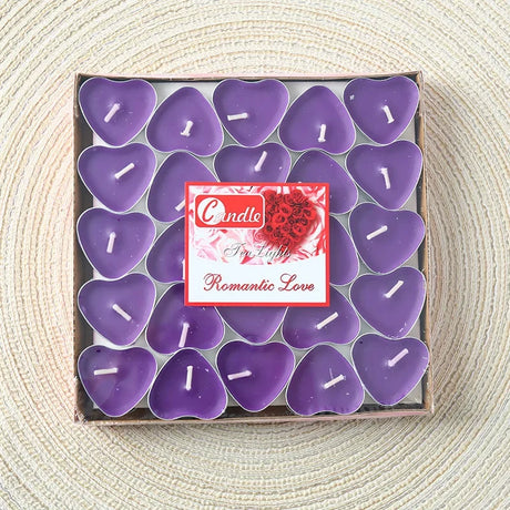 Box of purple heart-shaped candles with a brand label on a textured surface