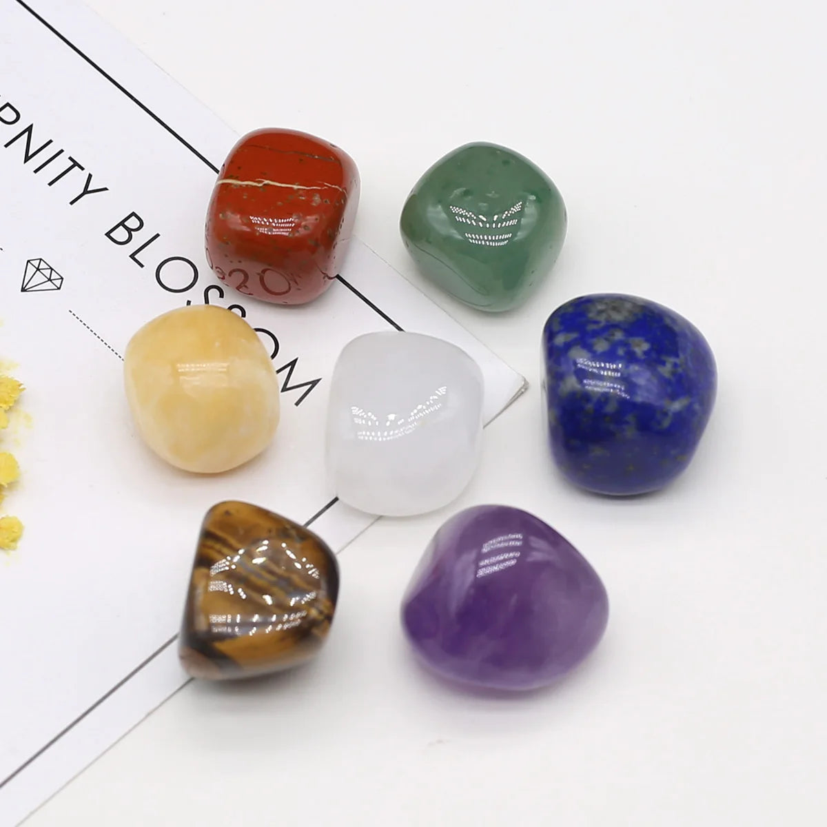 Set of colorful gemstones on a white background with 'Purity Blossom' branding.