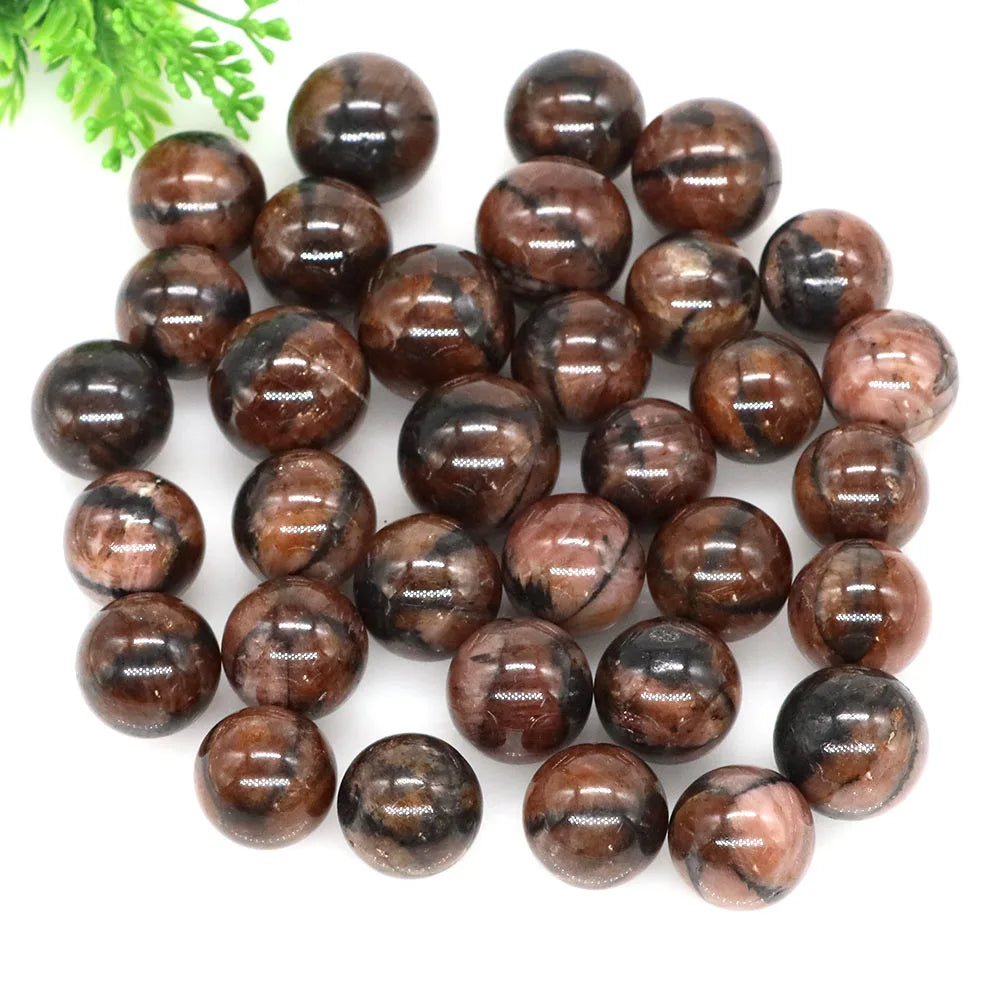 Brown marbled stones on a white background with green leaves.