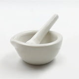 White ceramic mortar and pestle on a white background