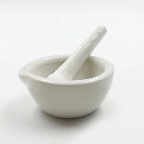 White ceramic mortar and pestle on a white background