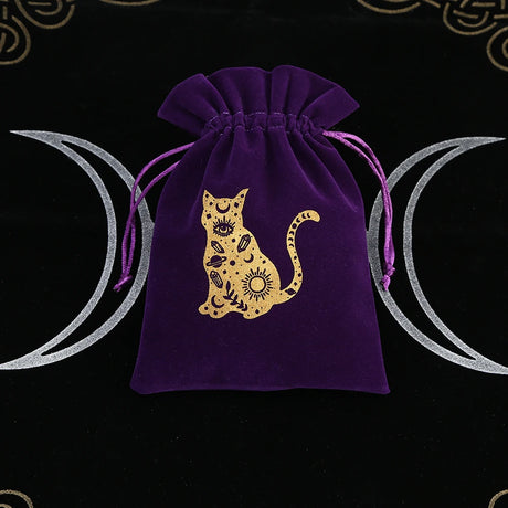 Purple drawstring bag with a gold cat design on a black background with moon symbols.