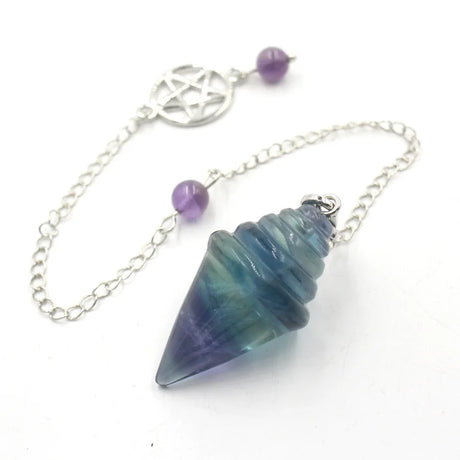 Crystal pendulum with chain and beads on a white background