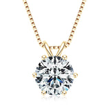 Gold necklace with a round diamond pendant on a white background