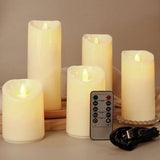 Set of five flameless candles with a remote control and power cord on a neutral background