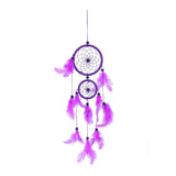 Purple dreamcatcher with feathers on a white background