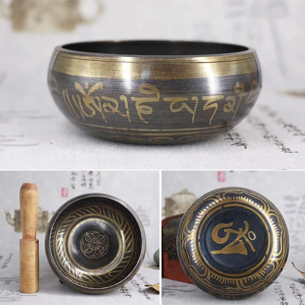Tibetan singing bowl set with engraved designs on a textured surface.