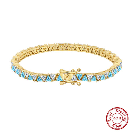 Gold bracelet with blue gemstones on a white background, featuring a 'Real Sterling Silver' stamp.