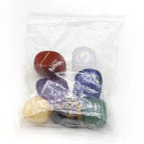 Set of colorful stones in a clear plastic bag on a white background