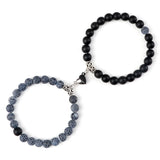 Beaded bracelet with black and gray beads on a white background