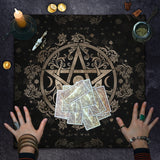 Tarot cards on a black cloth with a gold pentacle symbol, surrounded by candles and coins.