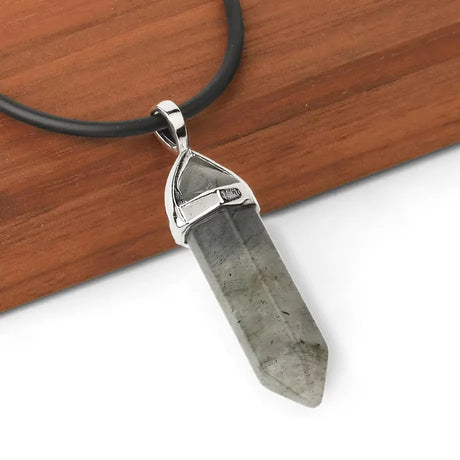 Crystal pendant necklace on a wooden surface