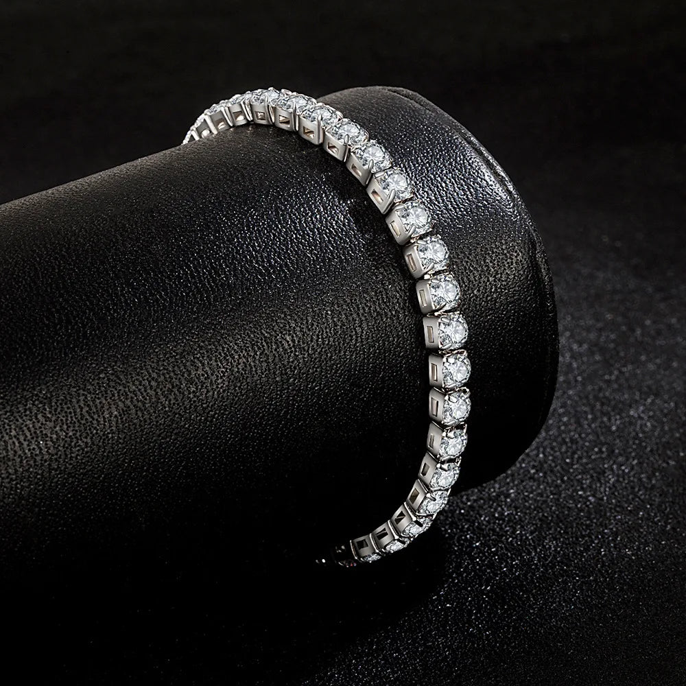 Diamond bracelet on a black cylindrical stand with a dark background