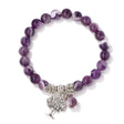 Purple beaded bracelet with a silver tree charm on a white background