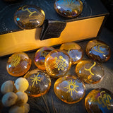 Transparent stones with yellow symbols on a textured surface