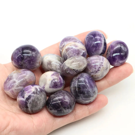  stones held in a hand on a white background