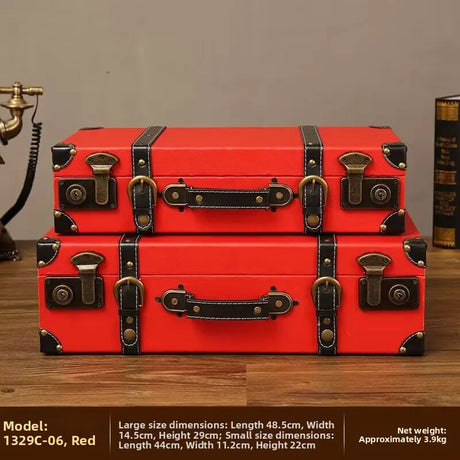 Two red vintage-style suitcases stacked on a wooden surface with product details.