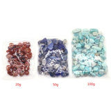 Three bags of different colored stones with weight labels on a white background