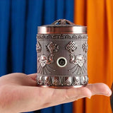 Decorative metal lantern held in a hand with colorful background