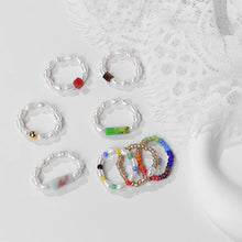Set of beaded bracelets on a textured white surface