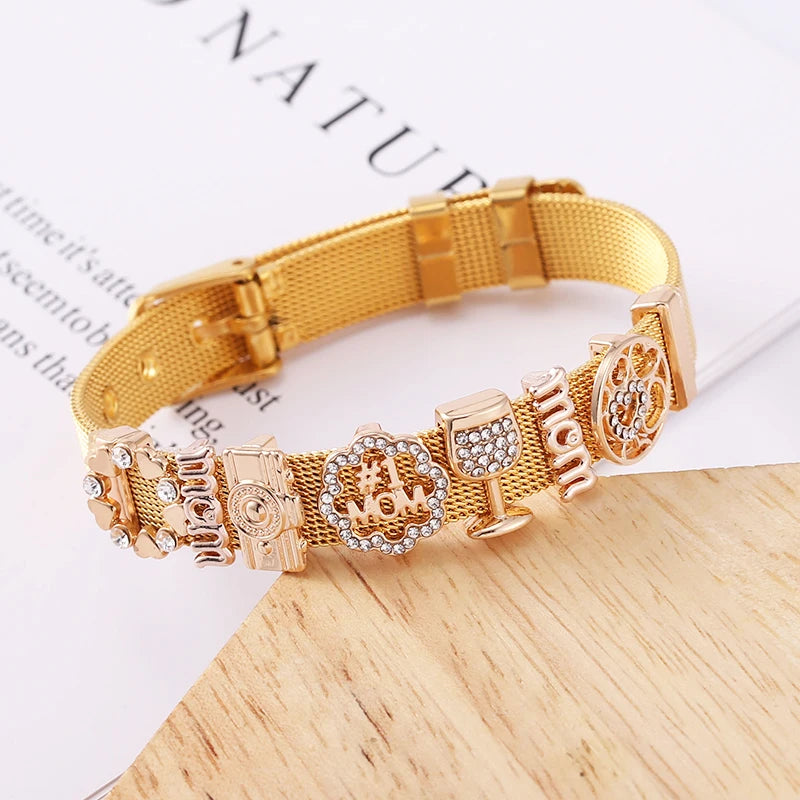 Gold dog collar with various charms on a wooden surface