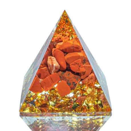 Triangular crystal with orange and yellow stones on a white background