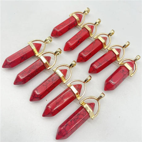 Red stone pendants with gold accents on a white background