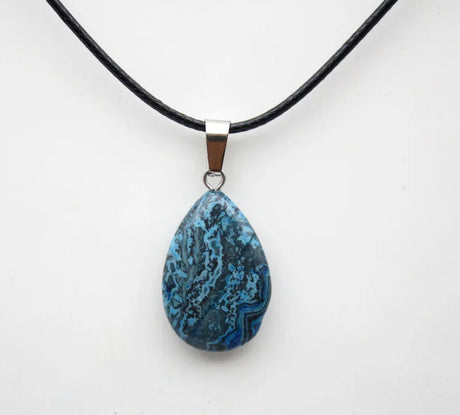 Teardrop-shaped blue pendant on a black cord against a white background