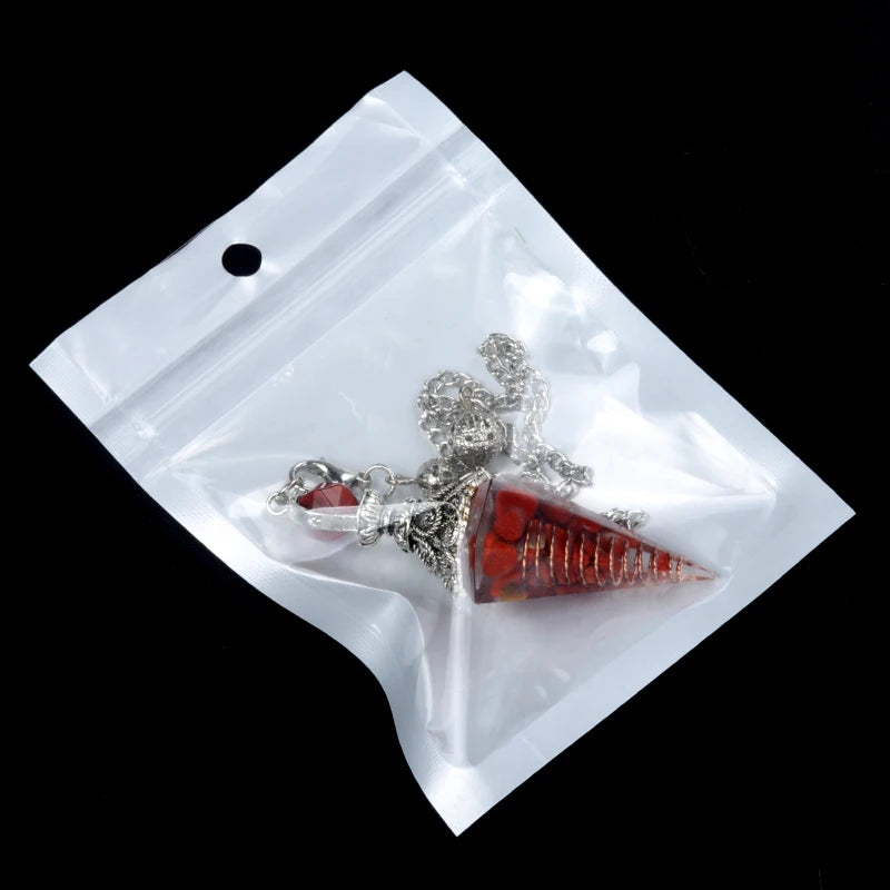 Necklace with red pendant in a clear plastic bag on a black background