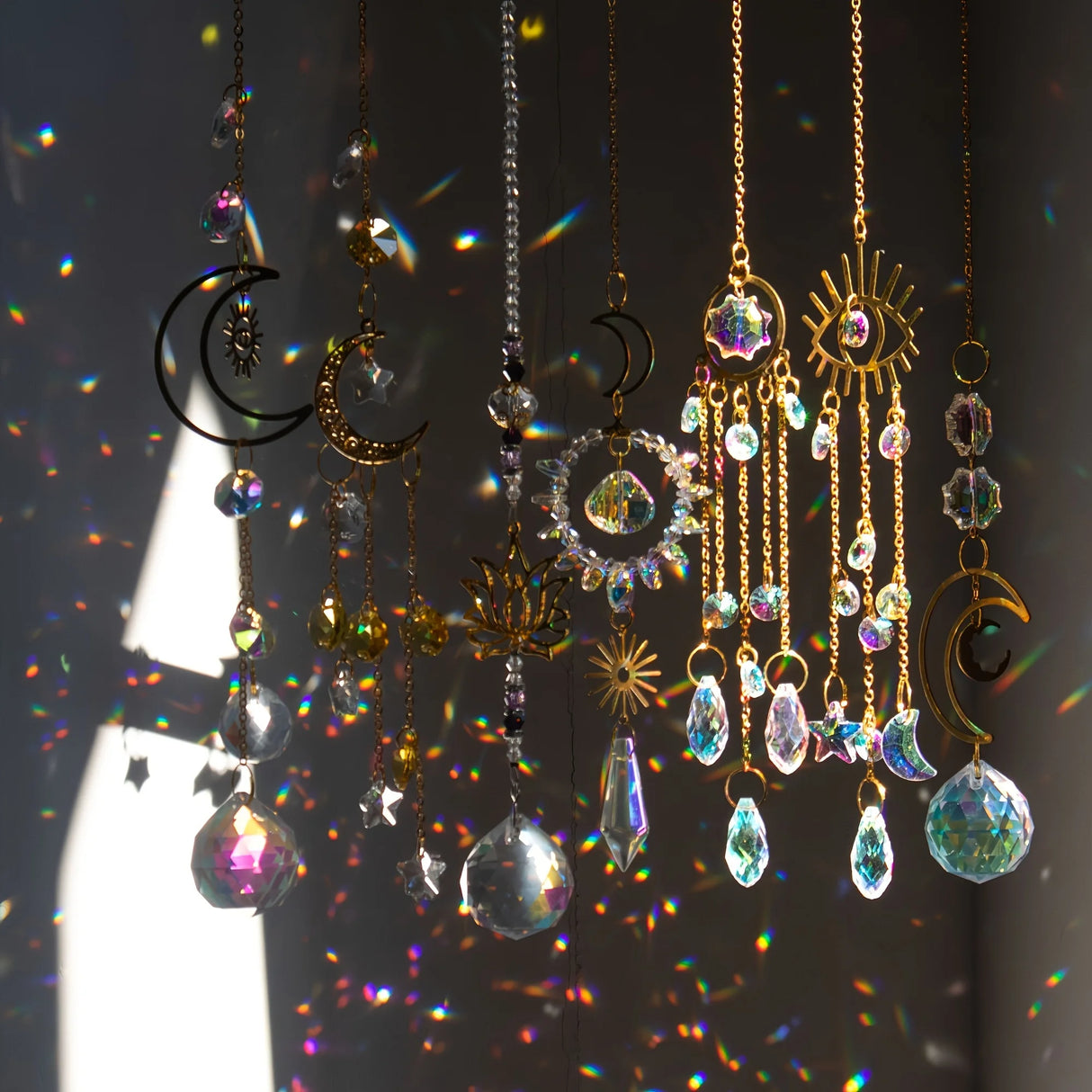 Decorative hanging ornaments with crystals and celestial designs on a dark background