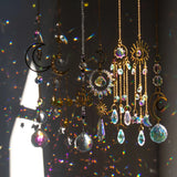 Decorative hanging ornaments with crystals and celestial designs on a dark background