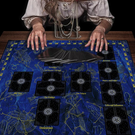 Person with tarot cards on a blue tarot tablecloth