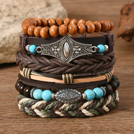 Stack of leather and beaded bracelets on a wooden surface