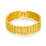 Gold bracelet with a textured design on a white background