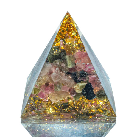 Pyramid-shaped crystal with embedded colorful stones on a white background